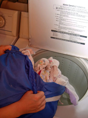 loading dirty diapers into washer